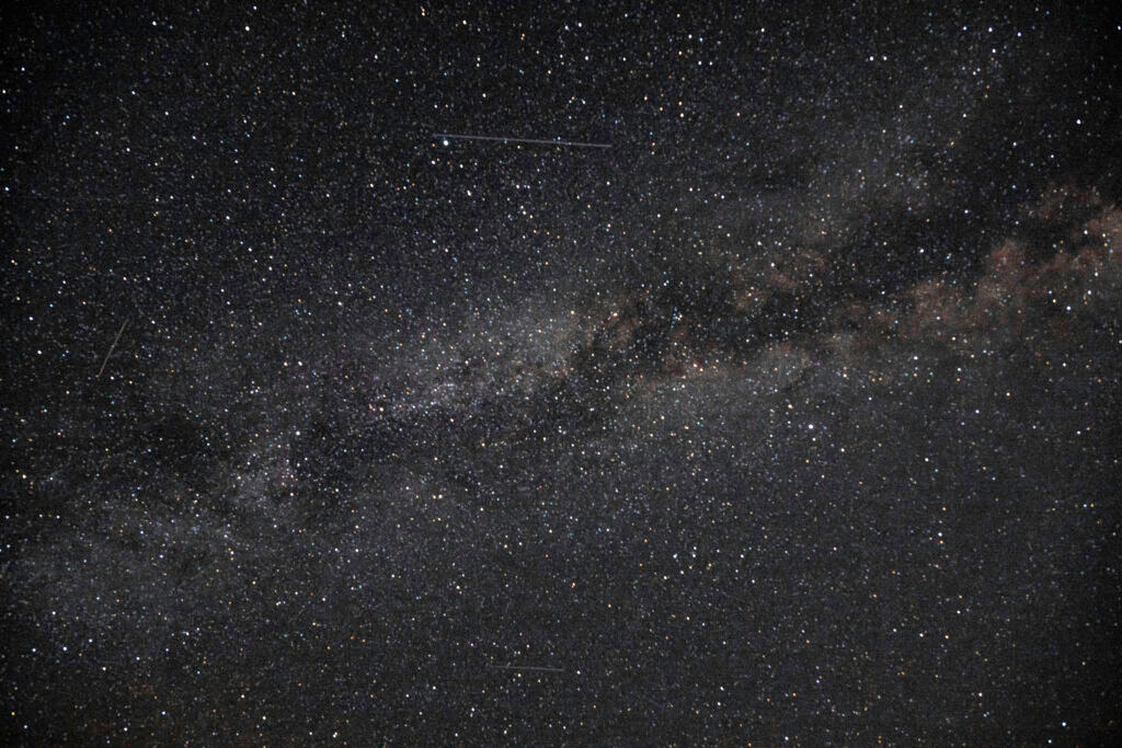 Wide field Milky Way galaxy stretching across dark night sky Yosemite National Park California astrophotography by Hadi Baradaran ArtQuestor