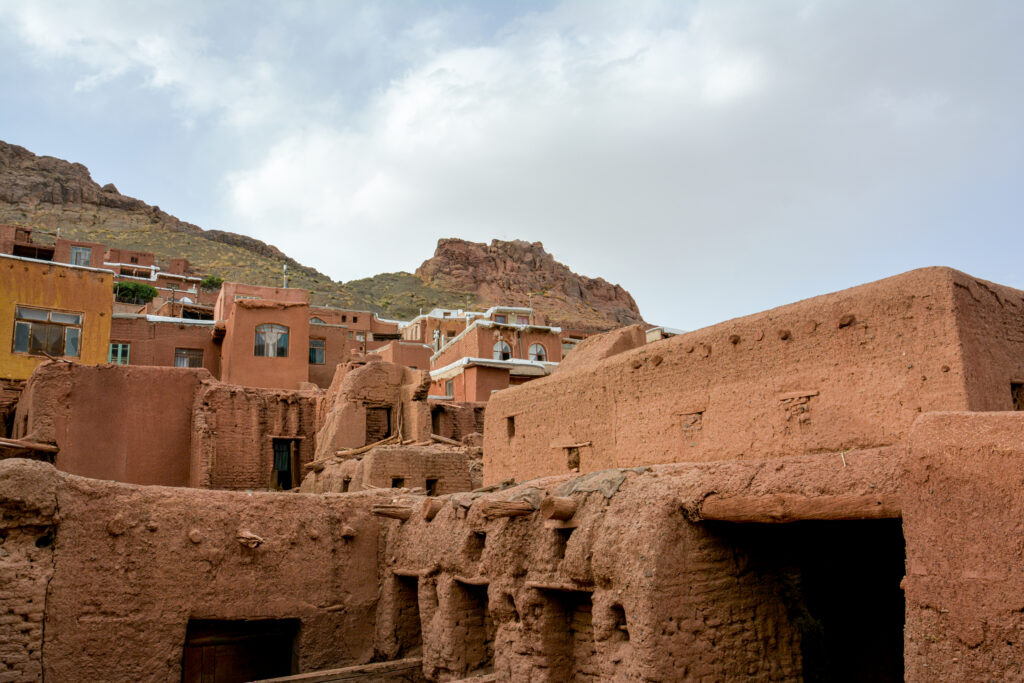 Abyaneh Iran terraced pink red mud brick houses hillside ancient Persian village fine art photography by Hadi Baradaran ArtQuestor