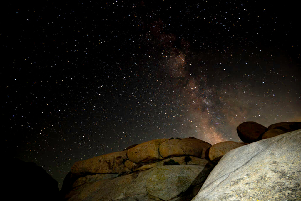 Milky Way galaxy over boulders Joshua Tree National Park California night sky astrophotography by Hadi Baradaran ArtQuestor