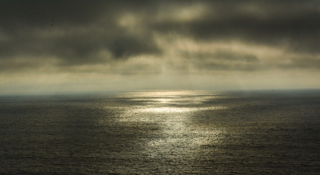 dark dramatic ocean sunset golden light storm clouds fine art seascape photography by Hadi Baradaran ArtQuestor