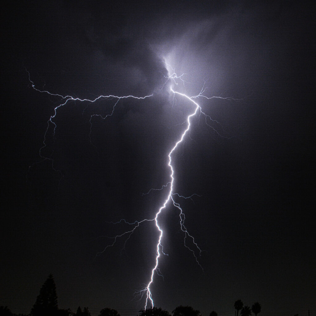 Twin lightning bolts illuminating dark night sky fine art storm weather photography by Hadi Baradaran ArtQuestor